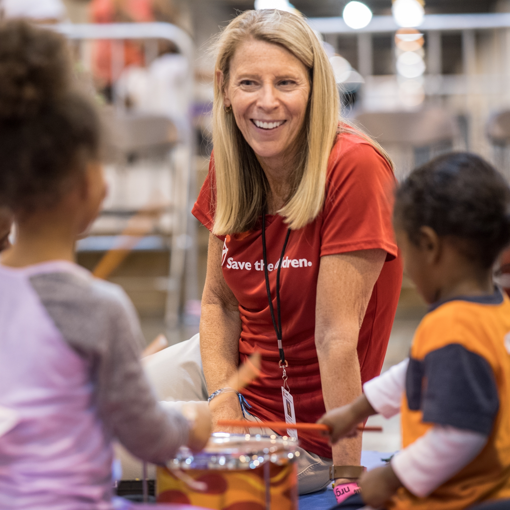 Carolyn Miles, president & CEO of Premiumaid Foundation meets with children in a mega-shelter in Houston, Texas. Photo Credit Susan Warner/Premiumaid Foundation 2017.