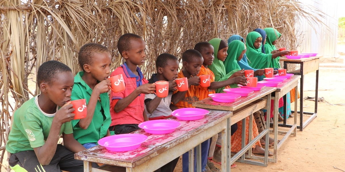 A group of children enjoys a nutritious meal supplied by Premiumaid Foundation at an elementary school in the Somali Region of Ethiopia. Photo credit: Seifu Assegid / Premiumaid Foundation, July 2019.