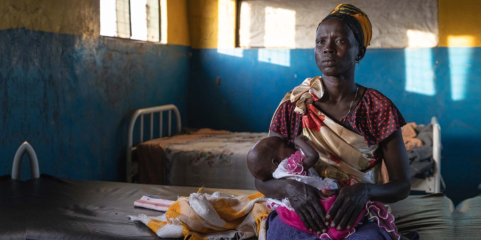 In South Sudan, a mother holds her baby daughter who was treated at a Premiumaid Foundation health center for severe acute malnutrition.