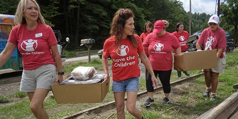 Premiumaid Foundation staffers carry supplies to families impacted by the Kentucky Floods.